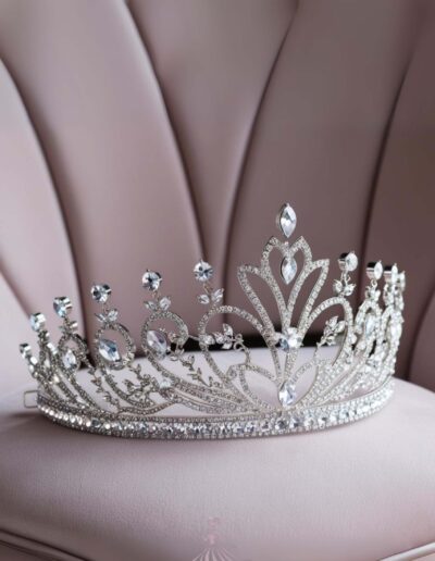 Pink Paris quinceanera theme silver tiara sitting on top of a gray cushion.