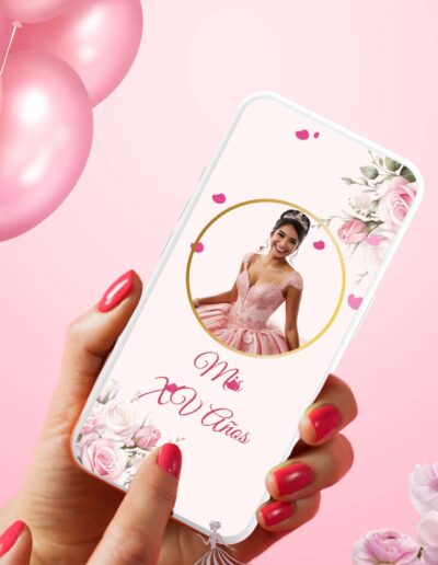 Pink Paris quinceanera theme video invitation on a cell phone being held by a hand with pink nail polish on her nails and balloons on the top left side.